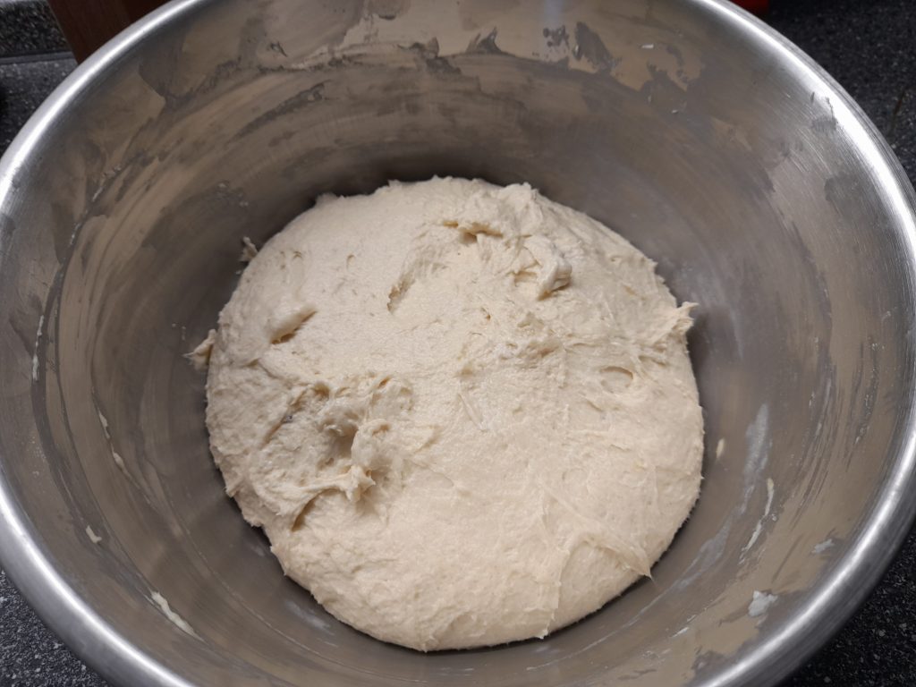 A bowl of dough for škvarkové pagáče, showcasing a fluffy and soft texture, ready for the next steps in the baking process.