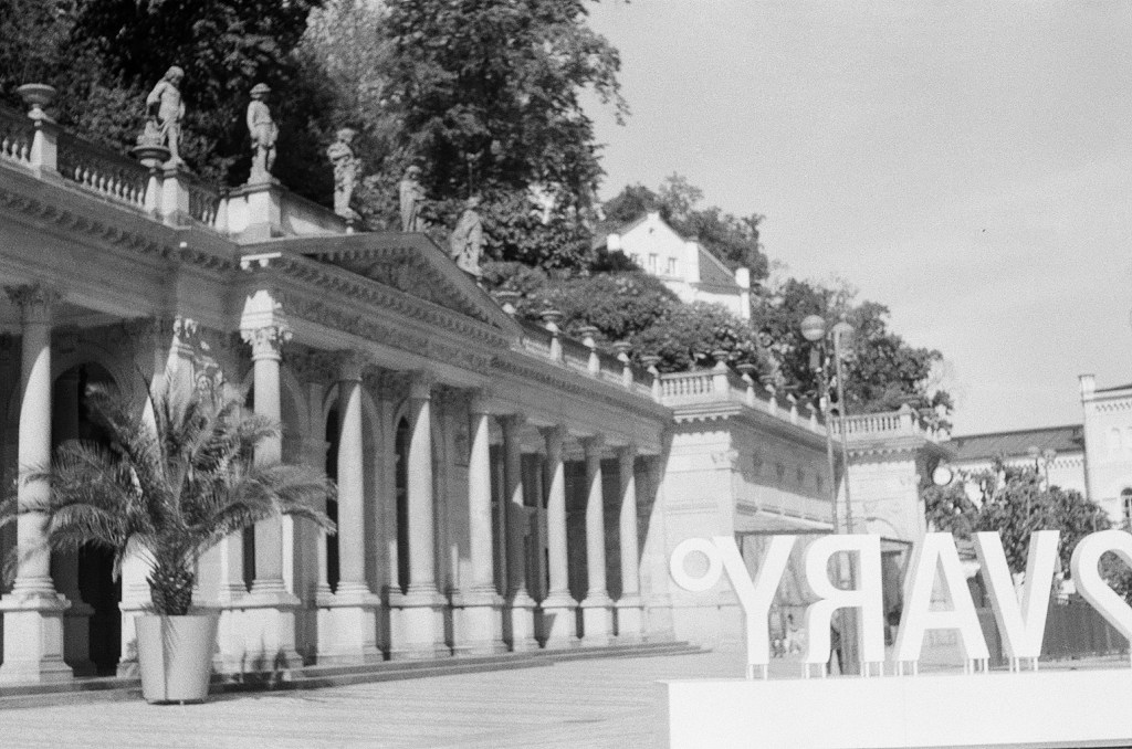 Film photograph of the Mill Colonnade (Mlýnská kolonáda) in Karlovy Vary with its arches and columns; winter light falling across the arcade.